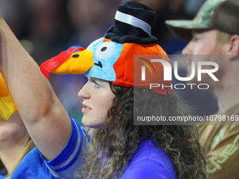 A fan wearing a turkey hat looks onto the field from the stands during  an NFL  football game between the Detroit Lions and the Chicago Bear...