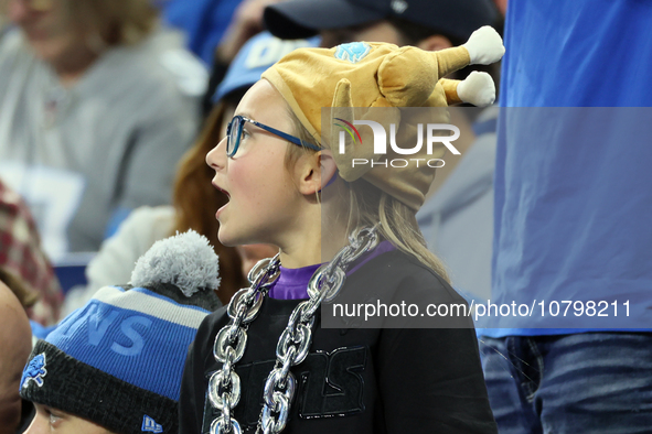 A fan wearing a turkey hat cheers from the stands during  an NFL  football game between the Detroit Lions and the Chicago Bears in Detroit,...