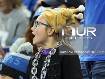 A fan wearing a turkey hat cheers from the stands during  an NFL  football game between the Detroit Lions and the Chicago Bears in Detroit,...