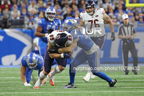 Chicago Bears tight end Cole Kmet (85) ia tackled by Detroit Lions linebacker Alex Anzalone (34) during the first half of an NFL football ga...