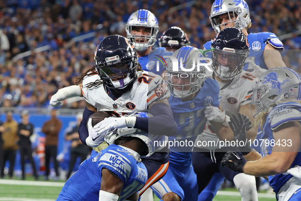 Chicago Bears running back D'Onta Foreman (21) is tackled by Detroit Lions safety Brian Branch (32) during the first half of an NFL football...