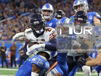 Chicago Bears running back D'Onta Foreman (21) is tackled by Detroit Lions safety Brian Branch (32) during the first half of an NFL football...