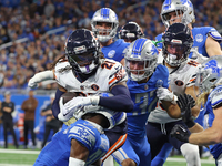 Chicago Bears running back D'Onta Foreman (21) is tackled by Detroit Lions safety Brian Branch (32) during the first half of an NFL football...