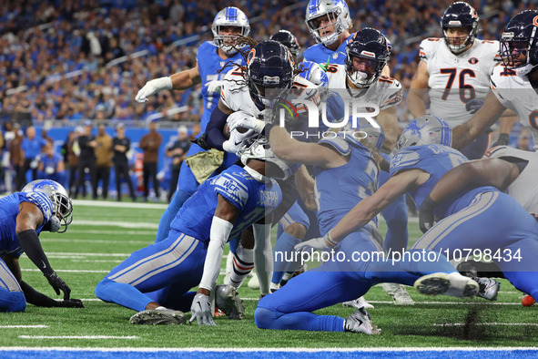 Chicago Bears running back D'Onta Foreman (21) is tackled by Detroit Lions safety Brian Branch (32) during the first half of an NFL football...