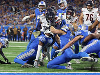 Chicago Bears running back D'Onta Foreman (21) is tackled by Detroit Lions safety Brian Branch (32) during the first half of an NFL football...