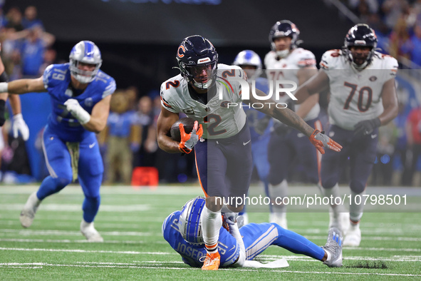 Chicago Bears wide receiver DJ Moore (2) runs the ball against Detroit Lions safety Kerby Joseph (31) during the first half of an NFL footba...