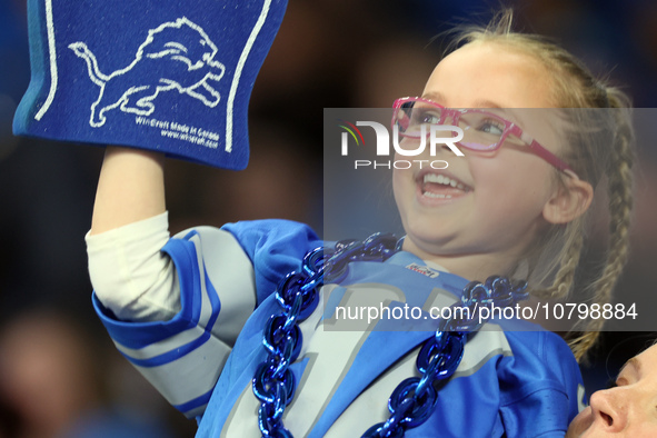 A young fan cheers in the stands during  an NFL  football game between the Detroit Lions and the Chicago Bears in Detroit, Michigan USA, on...