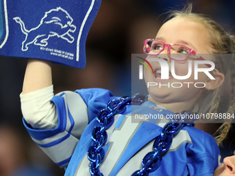 A young fan cheers in the stands during  an NFL  football game between the Detroit Lions and the Chicago Bears in Detroit, Michigan USA, on...