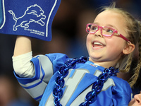 A young fan cheers in the stands during  an NFL  football game between the Detroit Lions and the Chicago Bears in Detroit, Michigan USA, on...