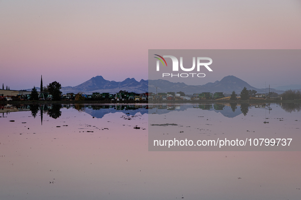 The sun rises over flooded California rice fields, during a storm break brought on by an atmospheric river near Marysville, Calif., on Sunda...