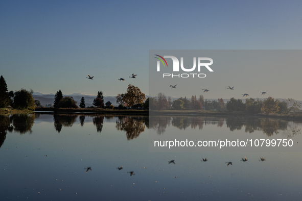 The sun rises over flooded California rice fields, during a storm break brought on by an atmospheric river near Marysville, Calif., on Sunda...