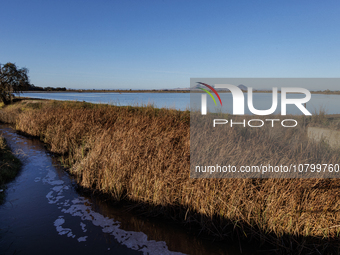 The sun rises over flooded California rice fields, during a storm break brought on by an atmospheric river near Marysville, Calif., on Sunda...