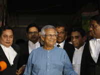 Nobel Peace Prize laureate and Grameen Telecom chairman Professor Muhammad Yunus with his lawyers seen seen in front of a labor court in Dha...