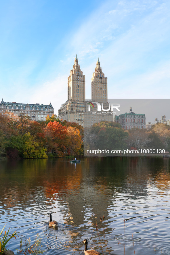 People enjoy a boat ride on The Lake as the autumn leaves appear in Central Park while enjoying the fall weather in New York City, New York...