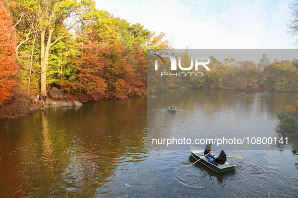 People are enjoying a boat ride on The Lake in Central Park, taking pleasure in the fall weather in New York City, New York, on November 6,...