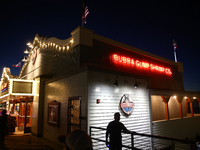 People are seen near Bubba Gump Shrimp Co. restaurant in Santa Monica, United States on November 12, 2023. (