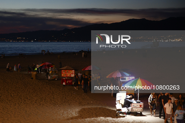 People are seen on the beach in Santa Monica, United States on November 12, 2023. 