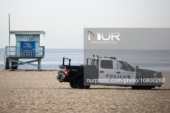 A lifeguard tower and police car are seen on the beach in Santa Monica, United States on November 13, 2023. 