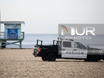 A lifeguard tower and police car are seen on the beach in Santa Monica, United States on November 13, 2023. (