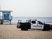 A lifeguard tower and police car are seen on the beach in Santa Monica, United States on November 13, 2023. (