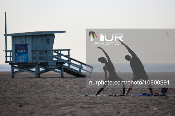 People exercise on the beach in Santa Monica, United States on November 13, 2023. 