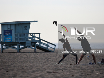 People exercise on the beach in Santa Monica, United States on November 13, 2023. (