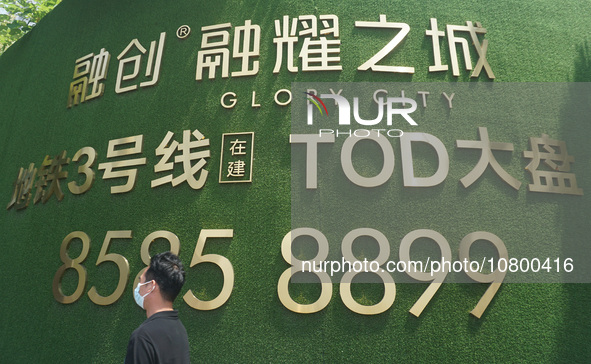 HANGZHOU, CHINA - NOVEMBER 21, 2023 - Citizens walk past a new construction Sunac China building in Hangzhou, east China's Zhejiang Province...