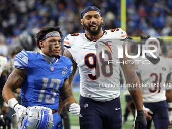 Detroit Lions running back Craig Reynolds (13) and Chicago Bears defensive end Montez Sweat (98) walk off the field after the conclusion of...