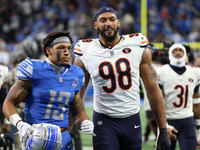 Detroit Lions running back Craig Reynolds (13) and Chicago Bears defensive end Montez Sweat (98) walk off the field after the conclusion of...