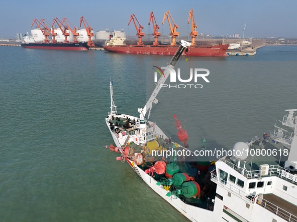 YANTAI, CHINA - NOVEMBER 21, 2023 - The ''Haixun 153'' navigation vessel releases a new beacon into the sea at the main channel of Longkou P...