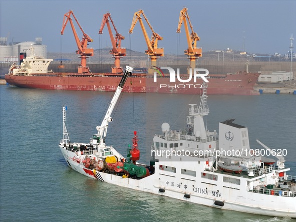 YANTAI, CHINA - NOVEMBER 21, 2023 - The ''Haixun 153'' navigation vessel releases a new beacon into the sea at the main channel of Longkou P...