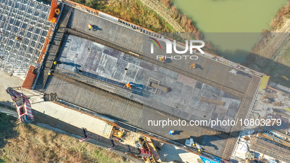 Workers are working at the construction site of the Xuancheng-Hangzhou Railway interchange in Huzhou, China, on November 22, 2023. 