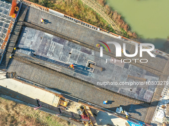 Workers are working at the construction site of the Xuancheng-Hangzhou Railway interchange in Huzhou, China, on November 22, 2023. (