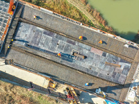 Workers are working at the construction site of the Xuancheng-Hangzhou Railway interchange in Huzhou, China, on November 22, 2023. (