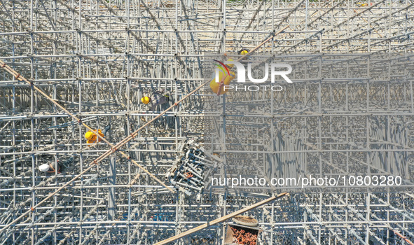 Workers are working at the construction site of the Xuancheng-Hangzhou Railway interchange in Huzhou, China, on November 22, 2023. 