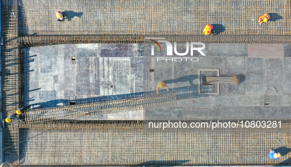 Workers are working at the construction site of the Xuancheng-Hangzhou Railway interchange in Huzhou, China, on November 22, 2023. 