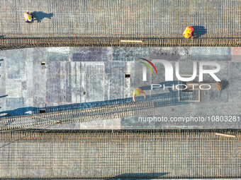 Workers are working at the construction site of the Xuancheng-Hangzhou Railway interchange in Huzhou, China, on November 22, 2023. (