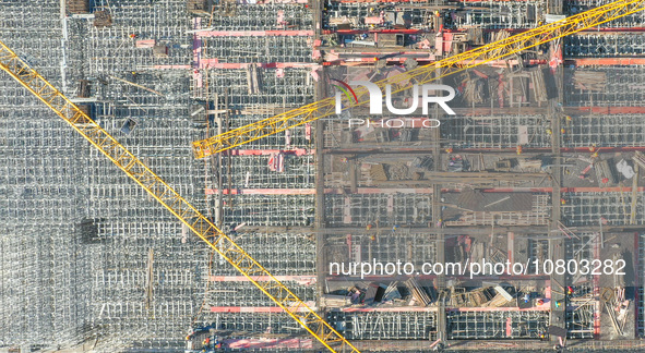 Workers are working at the construction site of the Xuancheng-Hangzhou Railway interchange in Huzhou, China, on November 22, 2023. 