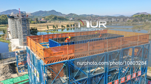 Workers are working at the construction site of the Xuancheng-Hangzhou Railway interchange in Huzhou, China, on November 22, 2023. 