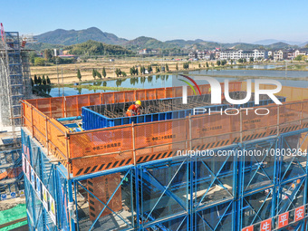 Workers are working at the construction site of the Xuancheng-Hangzhou Railway interchange in Huzhou, China, on November 22, 2023. (