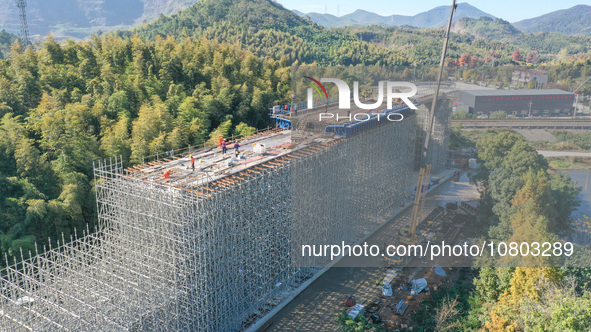 Workers are working at the construction site of the Xuancheng-Hangzhou Railway interchange in Huzhou, China, on November 22, 2023. 