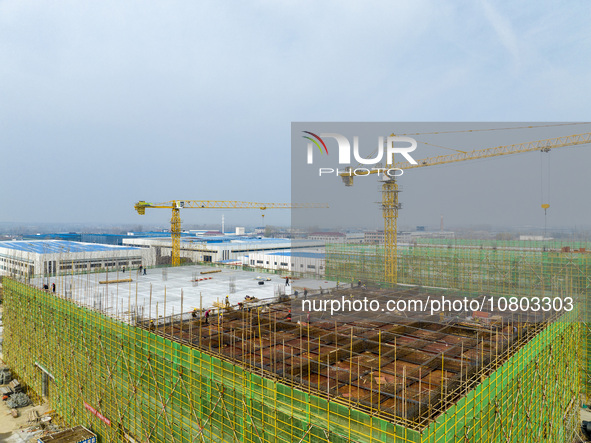 Workers are working at the construction site of a comprehensive utilization base for automobile recycling in Lianyungang, East China's Jiang...