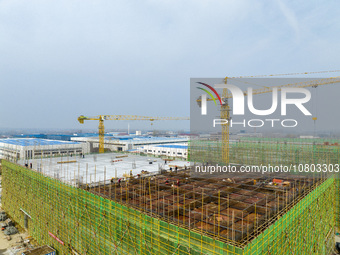 Workers are working at the construction site of a comprehensive utilization base for automobile recycling in Lianyungang, East China's Jiang...