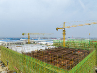 Workers are working at the construction site of a comprehensive utilization base for automobile recycling in Lianyungang, East China's Jiang...