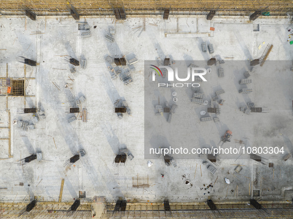 Workers are working at the construction site of a comprehensive utilization base for automobile recycling in Lianyungang, East China's Jiang...