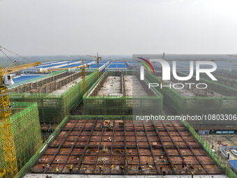 Workers are working at the construction site of a comprehensive utilization base for automobile recycling in Lianyungang, East China's Jiang...