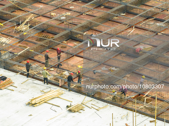 Workers are working at the construction site of a comprehensive utilization base for automobile recycling in Lianyungang, East China's Jiang...