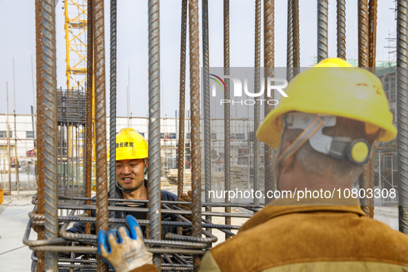 Workers are working at the construction site of a comprehensive utilization base for automobile recycling in Lianyungang, East China's Jiang...