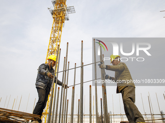 Workers are working at the construction site of a comprehensive utilization base for automobile recycling in Lianyungang, East China's Jiang...