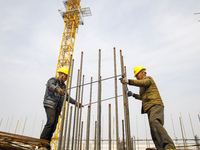 Workers are working at the construction site of a comprehensive utilization base for automobile recycling in Lianyungang, East China's Jiang...